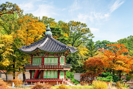 Amazing view of Hyangwonjeong Pavilion at beautiful autumn garden of Gyeongbokgung Palace in Seoul, South Korea. Wonderful pavilion of traditional Korean architecture among colorful trees.のeditorial素材