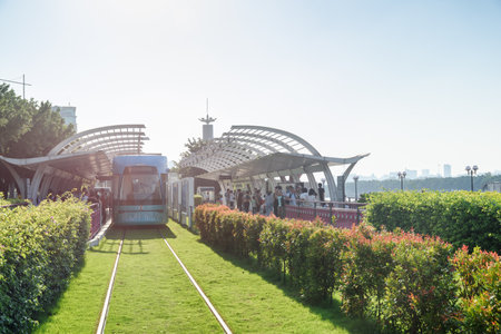 Guangzhou, China - September 16, 2017: Asian tourists on a tram stop. Guangzhou Trams are popular among tourists. The tram line connecting the Canton Tower and Wanshengwei along the Pearl River.のeditorial素材