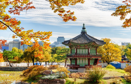 Wonderful view of Hyangwonjeong Pavilion on an artificial island of lake at Gyeongbokgung Palace in Seoul, South Korea. Classical pavilion of traditional Korean architecture. Colorful autumn cityscapeのeditorial素材