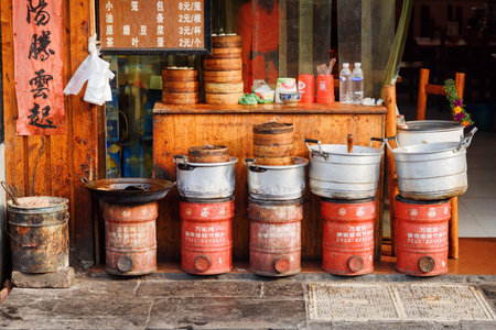 Fenghuang, China - September 23, 2017: Scenic row of cooking pots and Dim Sum baskets outside traditional Chinese restaurant in Phoenix Ancient Town (Fenghuang County).のeditorial素材