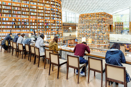 Seoul, South Korea - October 14, 2017: Visitors at the Starfield Library reading area. Huge bookshelves are visible in background. The public library is a popular attraction of Seoul.のeditorial素材