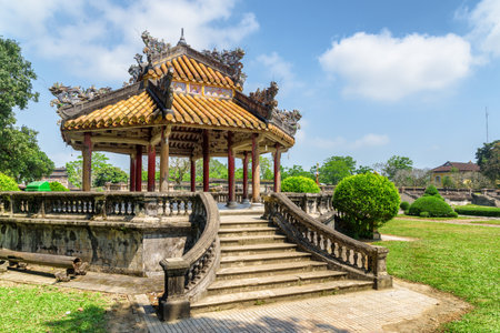 Scenic view of traditional Vietnamese pavilion on blue sky background at garden of the Imperial City on summer sunny day in Hue, Vietnam. Hue is a popular tourist destination of Asia.のeditorial素材
