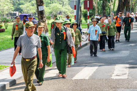 Hue, Vietnam - April 4, 2018: Group of Vietnamese veterans walking along road to the Imperial City...