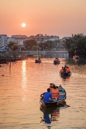 Hoi An (Hoian), Vietnam - April 11, 2018: Asian tourists traveling by boats along the Thu Bon River...