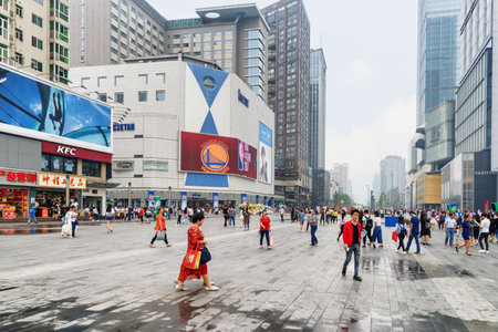 Chengdu, China - September 26, 2017: Asian tourists and residents walking along Pedestrian Street and Hongxing Road Walk Square with shopping malls at downtown of Chengdu.のeditorial素材