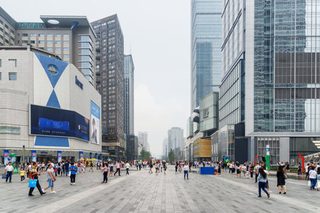 Chengdu, China - September 26, 2017: Asian tourists and residents walking along Hongxing Road Walk Square with shopping malls at downtown. Chengdu is a popular tourist destination of Asia.のeditorial素材