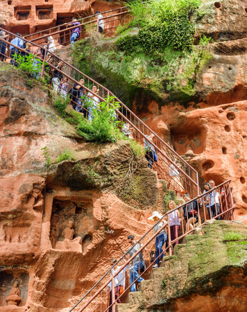 Leshan, China - September 28, 2017: Tourists going down stairs to the Leshan Giant Buddha. The Mount Emei Scenic Area is a popular tourist destination of Asia.のeditorial素材