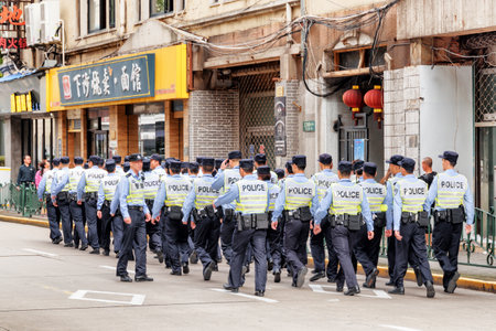 Shanghai, China - October 3, 2017: Policemen walking along street at downtown of Shanghai to the Bund (Waitan) to keep the embankment under control on the National Day holidays.のeditorial素材