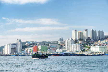 Scenic view of Busan in South Korea. Ship crossing Busan Harbor. Beautiful cityscape.の写真素材