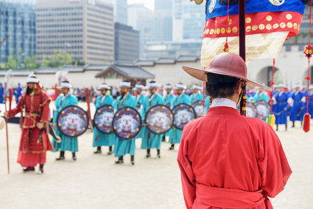 Seoul, South Korea - October 9, 2017: Back view of royal guard wearing red traditional military clothing Jeonbok. Performance with historical reconstruction at courtyard of Gyeongbokgung Palace.のeditorial素材