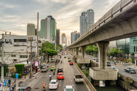 Bangkok, Thailand - 15 October, 2018: Wonderful view of Sathon Road at sunset. Street traffic of Bangkok. Viaduct of Silom Line and modern buildings. Beautiful cityscape.のeditorial素材