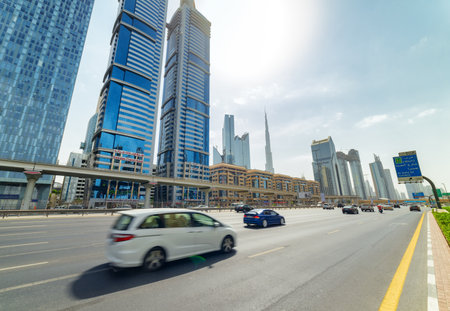 Dubai, United Arab Emirates - 2 November, 2018: Awesome view of Sheikh Zayed Road at downtown. The iconic Burj Khalifa Tower is visible on blue sky background. Day traffic of Dubai. Amazing cityscape.のeditorial素材