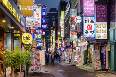 Seoul, South Korea - October 10, 2017: Amazing evening view of narrow street at downtown. Tourists and residents walking along bars and restaurants. Seoul is a popular tourist destination of Asia.のeditorial素材