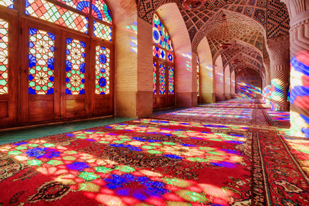 Gorgeous view of morning sunlight reflected through colorful stained glass windows on columns, the wall and the floor of prayer hall at the Nasir al-Mulk Mosque (Pink Mosque) in Shiraz, Iran.のeditorial素材
