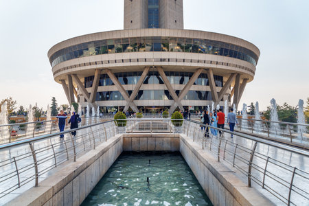 Tehran, Iran - 19 October, 2018: Scenic view of fountains and entrance to Milad Tower. The tower is...