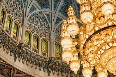 Muscat, Oman - 17 October, 2018: Beautiful view of ceiling and chandelier above the main prayer hall of the Sultan Qaboos Grand Mosque. Wonderful details of amazing interior of the Muslim place.のeditorial素材