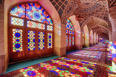 Awesome view of morning sunlight reflected through colorful stained glass windows on columns, the wall and the floor of prayer hall at the Nasir al-Mulk Mosque (Pink Mosque) in Shiraz, Iran.のeditorial素材