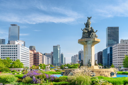 Seoul, South Korea - October 14, 2017: Scenic view of square in front of the National Assembly Proceeding Hall at Yeouido (Yeoui Island). Fountain and skyscrapers are visible on blue sky background.のeditorial素材