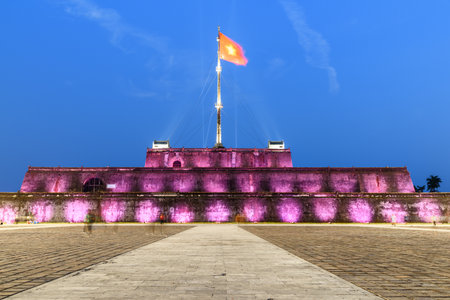 Night view of a square and the Flag Tower of the Citadel illuminated by pink lights in Hue, Vietnam. Within the Citadel is the Imperial City with the Purple Forbidden City.のeditorial素材
