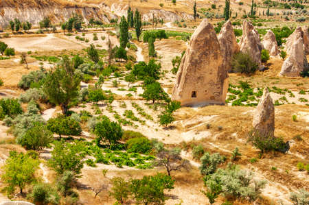 Beautiful landscape of Goreme National Park in Cappadocia, Turkey. Awesome view of scenic valley and Fairy Chimney Rock Formations. Cappadocia is a popular tourist destination of Turkey.