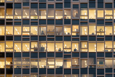 Closeup view of glowing windows of skyscraper. Modern office high-rise building.の写真素材