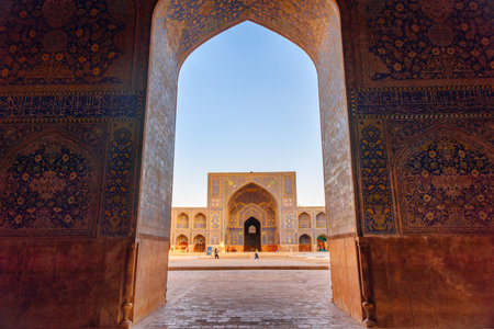 Isfahan, Iran - 23 October, 2018: Awesome view of courtyard of the Shah Mosque (Imam Mosque) through scenic arch. Wonderful Persian exterior of the Muslim place. Amazing Islamic architecture.のeditorial素材