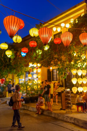 Hoi An (Hoian), Vietnam - April 11, 2018: Wonderful evening view of old cozy pedestrian street decorated with traditional colorful silk lanterns at Hoi An Ancient Town.のeditorial素材