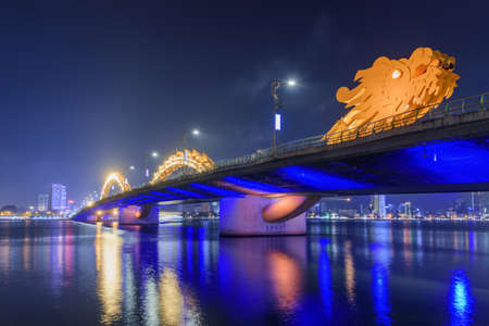 Fabulous night view of the Dragon Bridge (Cau Rong) over the Han River at downtown of Da Nang (Danang), Vietnam. Beautiful cityscape. The Dragon Bridge is a popular tourist attraction of Asia.の写真素材