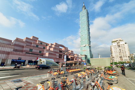 Taipei, Taiwan - April 26, 2019: Unusual view of Taipei 101 and orange YouBikes on Xinyi Road at...