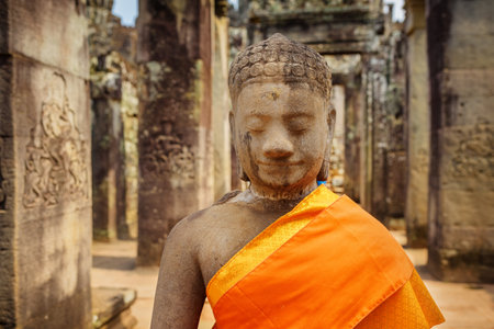 Siem Reap, Cambodia - May 2, 2015: Closeup view of ancient stone Buddha statue at Bayon temple in Angkor Thom. Angkor Thom is a popular tourist attraction of Asia.のeditorial素材
