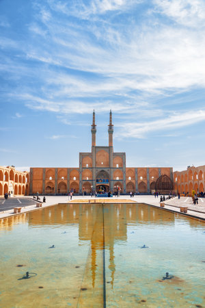 Yazd, Iran - 26 October, 2018: View of the Amir Chakhmaq Complex reflected in water reservoir in the middle of square at the historical city of Yazd. Unique Persian architecture of the ancient town.のeditorial素材