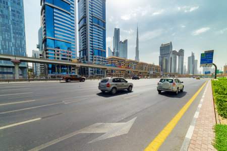 Dubai, United Arab Emirates - 2 November, 2018: View of Sheikh Zayed Road at downtown. The iconic Burj Khalifa Tower is visible on blue sky background. Day traffic of Dubai. Scenic cityscape.のeditorial素材