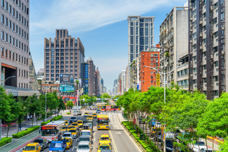 Taipei, Taiwan - April 25, 2019: Scenic view of Xinyi Road on sunny day. Day traffic of Taipei. Fabulous cityscape. Taiwan is a popular tourist destination of Asia.のeditorial素材