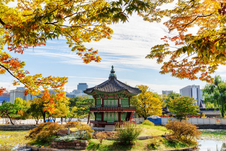 Amazing view of Hyangwonjeong Pavilion on an artificial island of lake at Gyeongbokgung Palace in Seoul, South Korea. Beautiful pavilion of traditional Korean architecture. Scenic autumn cityscape.のeditorial素材