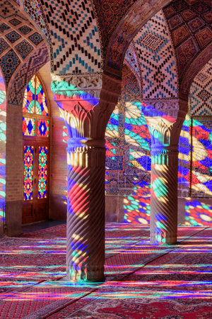 Shiraz, Iran - 31 October, 2018:  View of prayer hall at the Nasir al-Mulk Mosque (Pink Mosque). Sunlight reflected through stained glass windows on columns, the wall and the floor.のeditorial素材