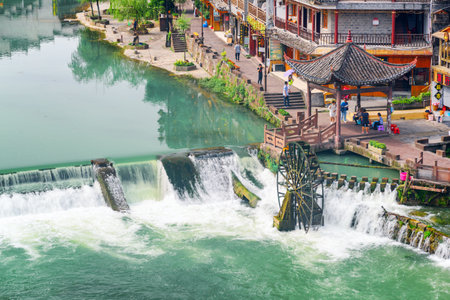 Fenghuang, China - September 23, 2017: Awesome aerial view of water wheel and scenic waterfall on the Tuojiang River (Tuo Jiang River) in Phoenix Ancient Town (Fenghuang County).のeditorial素材