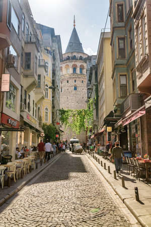 Istanbul, Turkey - September 15, 2021: View of the Galata Tower from an old narrow street. Istanbul is a popular tourist destination in the world.のeditorial素材