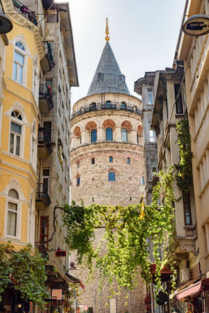 View of the Galata Tower from an old narrow street. Istanbul is a popular tourist destination in the world.の写真素材