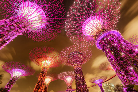 Singapore - February 18, 2017: Scenic night bottom view of the Supertrees and the Skyway at Gardens by the Bay. Giant tree-like structures and vertical gardens are popular tourist attraction of Asia.のeditorial素材