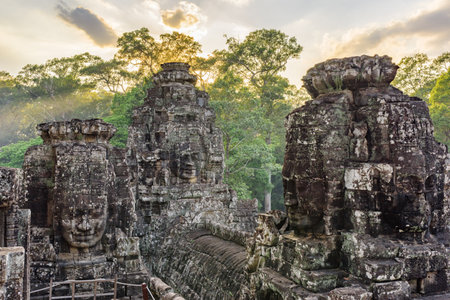 Giant stone faces of ancient Bayon temple. Bayon temple nestled in Angkor Thom, Siem Reap, Cambodia. Angkor Thom is a popular tourist attraction.の写真素材