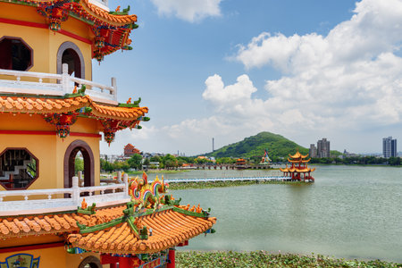 Kaohsiung, Taiwan - April 30, 2019: Awesome view of the Dragon and Tiger Pagodas at Lotus Lake. The temple is a popular tourist attraction of Asia. Wuliting is visible in background.のeditorial素材