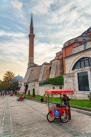 Istanbul, Turkey - September 15, 2021: Street vendors sell roasted chestnuts and simit (circular bread) by the Hagia Sophia. The Grand Mosque is a popular tourist attraction of the world.のeditorial素材