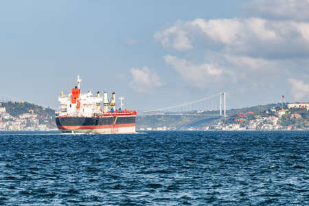 Tanker passes through the Bosporus. Awesome view of the Bosphorus Bridge (the 15 July Martyrs...