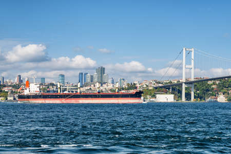 Tanker passes through the Bosporus. Awesome view of the Bosphorus Bridge (the 15 July Martyrs...