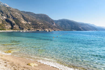 View of wonderful clear water of the Mediterranean Sea from Oludeniz Beach in Turkey. Scenic mountains are visible in background. Oludeniz is a popular tourist attraction in Turkey.の写真素材