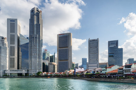 Singapore - February 19, 2017: Skyscrapers at downtown in Boat Quay, Singapore. Modern high-rise buildings on blue sky background. Beautiful summer cityscape.のeditorial素材