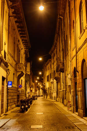 Night view of narrow street at historic centre of Verona, Italy. Verona is a popular tourist destination of Europe.の写真素材
