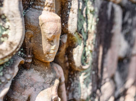 Wall sculpture in ancient Preah Khan temple in amazing Angkor in morning sun. Siem Reap, Cambodia. Enigmatic Preah Khan nestled among rainforest. Angkor is a popular tourist attraction.の写真素材