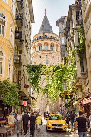 Istanbul, Turkey - September 15, 2021: View of the Galata Tower from an old narrow street. Istanbul is a popular tourist destination in the world.のeditorial素材