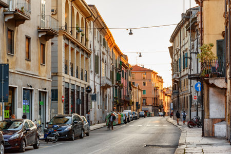 Verona, Italy - August 24, 2014: View of narrow street at historic centre of Verona, Italy. Facades of houses in morning sun. Verona is a popular tourist destination of Europe.のeditorial素材